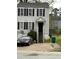 Two story home with gray siding, black shutters, front yard, and a staircase leading to the front door at 3464 Kingswood Trl, Decatur, GA 30034