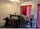 View of a room with neutral walls, carpeted floors, a dark table, and maroon curtains at 3464 Kingswood Trl, Decatur, GA 30034
