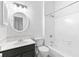 Modern bathroom with a vanity, updated lighting, and a tiled shower-tub combination at 3468 Washington Way, Doraville, GA 30340