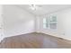 Sun-filled bedroom featuring wood flooring, a ceiling fan, and a large window at 3468 Washington Way, Doraville, GA 30340