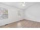 Bright bedroom features two windows, hardwood floors, and neutral walls at 3468 Washington Way, Doraville, GA 30340