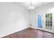 Bright dining area featuring wood floors, double doors to the outside, and a stylish chandelier at 3468 Washington Way, Doraville, GA 30340