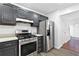 Modern kitchen with stainless steel appliances and sleek gray cabinetry at 3468 Washington Way, Doraville, GA 30340