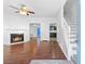 Bright living room features a cozy fireplace, hardwood floors, and staircase at 3468 Washington Way, Doraville, GA 30340