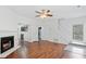 Open-concept living room featuring hardwood floors, fireplace, and easy access to the kitchen at 3468 Washington Way, Doraville, GA 30340