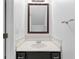 Elegant powder room features a framed mirror and a modern vanity with marble countertops at 3468 Washington Way, Doraville, GA 30340