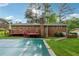 Backyard view featuring a spacious deck, brick exterior and an in-ground pool at 4616 Greensprings Rd, Atlanta, GA 30337