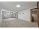 The renovated basement features neutral carpeting, natural light, and arched doorways at 4616 Greensprings Rd, Atlanta, GA 30337