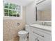 This bathroom offers a mosaic tiled accent wall, modern vanity, and bright window view at 4616 Greensprings Rd, Atlanta, GA 30337