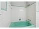 Bathroom with a vintage green tub, white tile, and chrome fixtures at 4616 Greensprings Rd, Atlanta, GA 30337