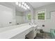 Bathroom with a long white countertop, a large mirror, and green and white accents at 4616 Greensprings Rd, Atlanta, GA 30337