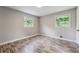 Bright bedroom with neutral walls, wood-look floors, and two windows providing natural light at 4616 Greensprings Rd, Atlanta, GA 30337