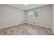 Bright bedroom with neutral walls, wood-look floors, and a window providing natural light at 4616 Greensprings Rd, Atlanta, GA 30337
