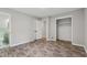 Bedroom featuring wood-look floors, neutral walls, and an open closet and bathroom at 4616 Greensprings Rd, Atlanta, GA 30337