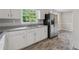 Clean kitchen with modern appliances, granite countertops, and durable wood-look vinyl flooring at 4616 Greensprings Rd, Atlanta, GA 30337