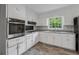 Modern kitchen featuring updated appliances, sleek countertops, and stylish wood-look floors at 4616 Greensprings Rd, Atlanta, GA 30337