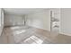 Spacious living room featuring neutral carpet, fresh gray paint, and an open layout at 4616 Greensprings Rd, Atlanta, GA 30337