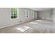 Bright and airy living room with neutral carpeting and natural light from large windows at 4616 Greensprings Rd, Atlanta, GA 30337