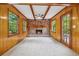 Inviting living room with a brick fireplace, wood paneled walls, and beamed ceiling accents at 4616 Greensprings Rd, Atlanta, GA 30337