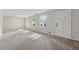 Bright living room with neutral carpet, light gray walls, and lots of natural light from multiple windows at 4616 Greensprings Rd, Atlanta, GA 30337