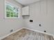 Room with gray walls, wood-look floors, a window, and white cabinets at 4616 Greensprings Rd, Atlanta, GA 30337