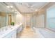 Elegant bathroom featuring double sinks, a soaking tub, and a separate glass-enclosed shower for a spa-like experience at 1460 Badingham Dr, Cumming, GA 30041