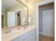 Bathroom with double vanity, large mirror, and access to the connecting rooms at 1460 Badingham Dr, Cumming, GA 30041