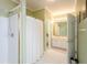 Bathroom with white tile, walk-in shower with curtain, and a vanity with ample storage space at 1460 Badingham Dr, Cumming, GA 30041
