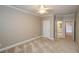 Neutral bedroom featuring plush carpeting, and a ceiling fan at 1460 Badingham Dr, Cumming, GA 30041