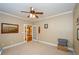 Bedroom showcasing neutral walls, with a ceiling fan, and doorway to other rooms at 1460 Badingham Dr, Cumming, GA 30041