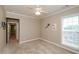 Bedroom featuring neutral decor, plush carpeting, ceiling fan, and a window providing natural light at 1460 Badingham Dr, Cumming, GA 30041
