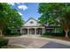 Elegant clubhouse with white columns, covered porch, and manicured landscaping at 1460 Badingham Dr, Cumming, GA 30041