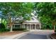 Charming clubhouse featuring a covered entrance, seating, and lush greenery at 1460 Badingham Dr, Cumming, GA 30041