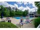 Large community pool with plenty of seating and shade, ideal for relaxation and socializing on warm summer days at 1460 Badingham Dr, Cumming, GA 30041