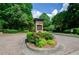 Community entrance sign with stone accents and mature landscaping at 1460 Badingham Dr, Cumming, GA 30041