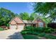 Beautiful brick home with a two-car garage and lush landscaping, offering great curb appeal at 1460 Badingham Dr, Cumming, GA 30041