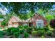 Beautiful brick home with well-manicured landscaping and a two-car garage at 1460 Badingham Dr, Cumming, GA 30041