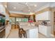 Open-concept kitchen with an island, stainless appliances, and connection to a cozy living area with large windows at 1460 Badingham Dr, Cumming, GA 30041