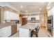 Well-appointed kitchen with stainless steel appliances, an island with bar seating, and ample counter space at 1460 Badingham Dr, Cumming, GA 30041