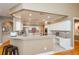 Bright kitchen with white cabinets, stone countertops, and a breakfast bar area perfect for entertaining at 1460 Badingham Dr, Cumming, GA 30041