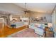Spacious living room featuring hardwood floors, ceiling fan, and an open floor plan to the kitchen at 1460 Badingham Dr, Cumming, GA 30041