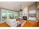 Comfortable living room featuring a fireplace, built-ins, hardwood floors, and many windows at 1460 Badingham Dr, Cumming, GA 30041
