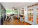 Cozy screened-in porch featuring a ceiling fan and wooden deck, perfect for outdoor relaxation and enjoyment at 1460 Badingham Dr, Cumming, GA 30041