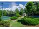 Scenic view of the tennis courts surrounded by lush landscaping and a charming clubhouse for post-match gatherings at 1460 Badingham Dr, Cumming, GA 30041
