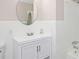 Clean bathroom with a white vanity, oval mirror, and a shower/tub combination at 1887 King Charles Sw Rd, Atlanta, GA 30331