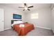 Cozy bedroom with neutral walls, plush carpeting, and a comfortable bed with a warm-toned comforter at 1887 King Charles Sw Rd, Atlanta, GA 30331