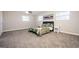 Spacious bedroom with plush gray carpet, ceiling fan, and bedside tables flanking a bed with a patterned green quilt at 1887 King Charles Sw Rd, Atlanta, GA 30331