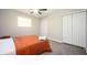 Comfortable bedroom featuring plush carpet, modern ceiling fan, and plenty of storage space with double door closet at 1887 King Charles Sw Rd, Atlanta, GA 30331