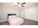 This bedroom features plush carpet, a ceiling fan, and a spacious closet at 1887 King Charles Sw Rd, Atlanta, GA 30331