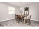 An elegant dining room offers stylish decor, gray-toned flooring, and a light fixture above a rustic table at 1887 King Charles Sw Rd, Atlanta, GA 30331